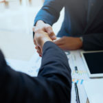 Successful business peolple handshaking after good deal.